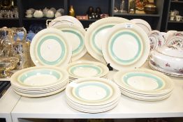 A quantity of Susie Cooper Burslem pattern dinner wares, hand painted with green, yellow and grey