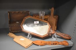 An oak vanity mirror decorated with floral patterns, L40cm, sold together with a miniature settle, a