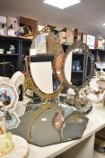 A vintage table top oval dresser mirror having floral frame, h58.5cm, sold together another