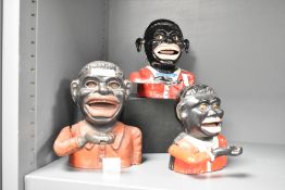 An early 20th century cast iron jolly gent money box, h16cm, sold together with two others, (3)