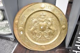 Two large brass alms dishes embossed with coat of arms, w77cm, (2)