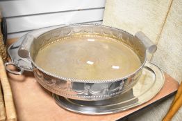 A large white metal circular serving tray having scroll handles and fringe decoration, w48cm, sold