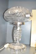 A 20th century cut glass mushroom form table lamp having chrome collar and geometrical patterns,