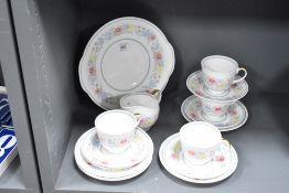 A Susie Cooper fine bone china part tea service, decorated with floral patterns on a white ground,