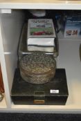 A metal circular trinket box with cover, having floral patterns, w17cm sold together with a