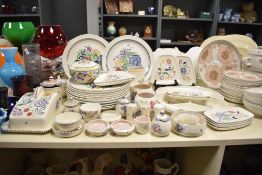 A Poole pottery dinner wares hand decorated with floral patterns, having printed mark to base, to