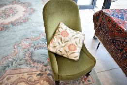 A vintage green dralon nursing chair, on the Victorian style having stained turned legs