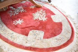 A Chinese rug, of oval form