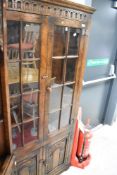 A Titchmarsh and Goodwin oak bookcase with cupboard to base, dimensions approx. height 168cm,