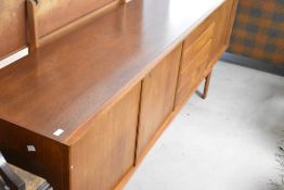 A vintage teak long john style sideboard , comprising double cupboard, four drawers and single