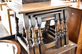 A vintage oak nest of three tables