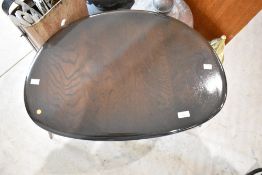 A nest of dark stained Ercol pebble style occasional tables