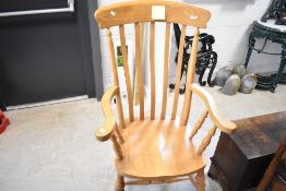 A traditional beech framed country style carver chair