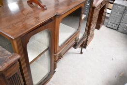 An early 20th Century mahogany display cabinet having central breakfront glazed section over