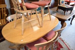 A modern limed oak dining table and six similar chairs, labelled for Philip Greenwood