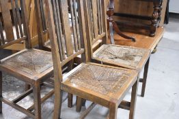 A set of four early 20th Century oak dining chairs and An early 20th century oak wind our dining