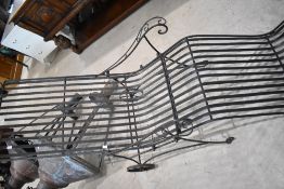 A modern wrought iron steamer style sun lounger