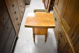 A 1930s occasional table having fold over table