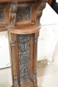 A 19th Century oak fire surround , having heavily carved decoration, width approx. 158cm