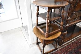 A pair of traditional oak occasional coffee tables with undershelves, diameter approx. 61cm