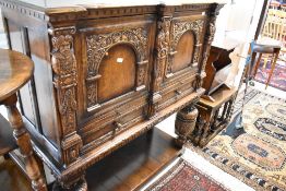 A Titchmarsh and Goodwin oak court cupboard having double cupboards over slide and drawers