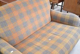 A Tetrad settee , in tartan upholstery, width approx. 153cm (slight pull to fabric)