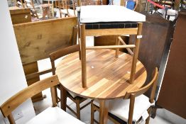 A modern Ikea Nackanas circular breakfast table and four chairs