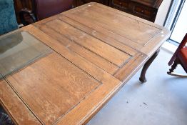 An early 20th century oak wind our dining table