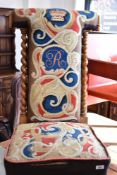 A Victorian stained frame prayer chair (prie dieu), having woolwork upholstery