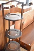 A vintage oak folding cake stand