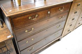 A Georgian oak chest of two over three drawers having brass drop handles , on bracket feet, width
