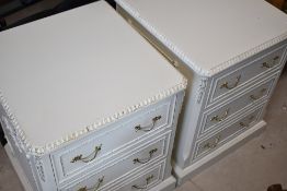 A pair of vintage white continental style bedside chests