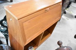 A vintage teak bureau in the G plan style, with bookcase under
