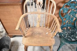 A stripped Windsor style armchair, having H stretcher