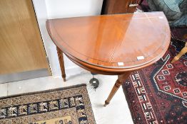 A reproduction half moon hall table