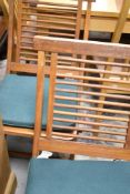 A set of four teak folding garden chairs