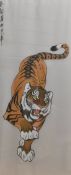 A 20th century Chinese painting on silk, depicting a tiger with Chinese characters upper left,