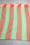 A large wool blanket decorated with green and red geometric patterns, w120cm