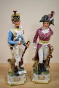 Two vintage ceramic figures depicting Napoleonic soldiers
