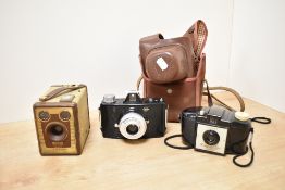 Three cameras. An Agfa Click 1, a Kodak Brownie 127, and a Kodak Brownie Six-20 Model F box camera