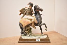 A large Capodimonte porcelain figure depicting French Hussar on horseback having damage to hat,