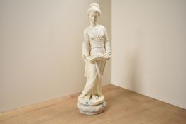 A cast composition figurine depicting a female holding a long basket flowers on marble base,