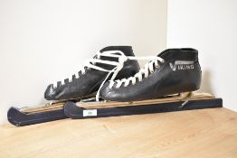 A pair of vintage Viking ice skates, in black leather with plastic blade caps still attached, size