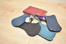 Five vintage leather coin purses. Four are navy and/or brown and have key rings attached, one is red
