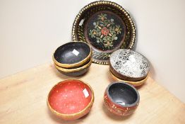 A paper mache fruit bowl, hand painted with floral patterns on a black ground, w25cm, sold