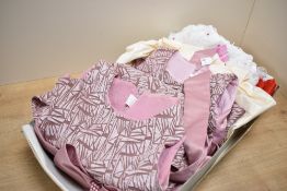 Four modern child's bridesmaid or occasion dresses, comprising two mauve satin and velvet styles,