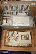 A box containing various vintage cigarette cards and post cards, subjects include railwayana and