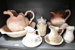 A selection of large and small decorative water jugs and bowls with matching storage jars