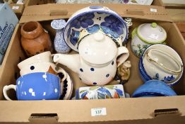 A clay pottery tea pot with cover, decorated with polka dot patterns on a white glaze ground, h21cm,