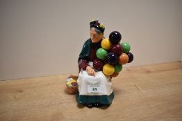 A Royal Doulton bone china figurine 'Old Balloon Seller', model number HN 1315, measuring 20cm.